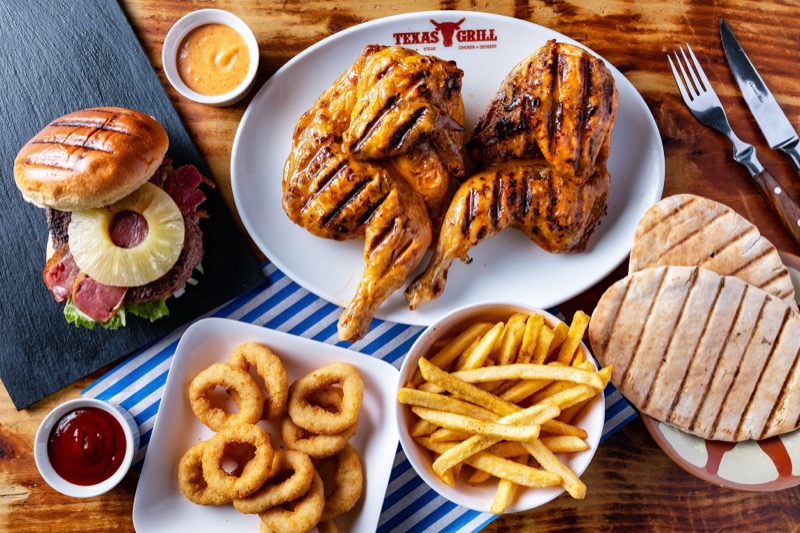 Texas Grill spread — whole chicken, burger, onion rings and fries
